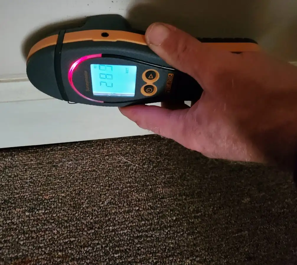 Moisture detection at baseboard during Storm Damage Restoration in Highland